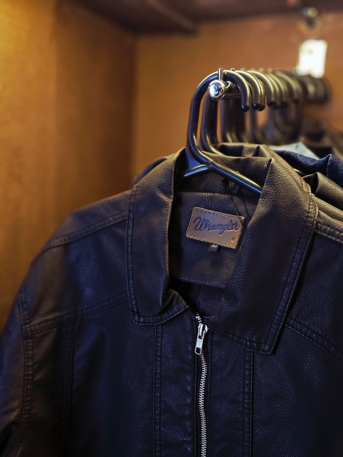 about-me-01 Stylish black leather jackets neatly hung on hangers inside a closet, showcasing fashion detail.